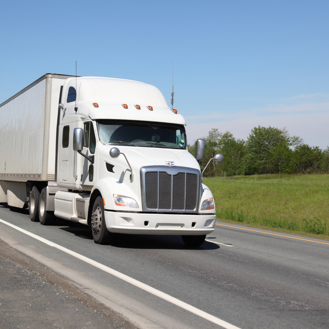Earth Logistics white Peterbilt semi-truck on US highway