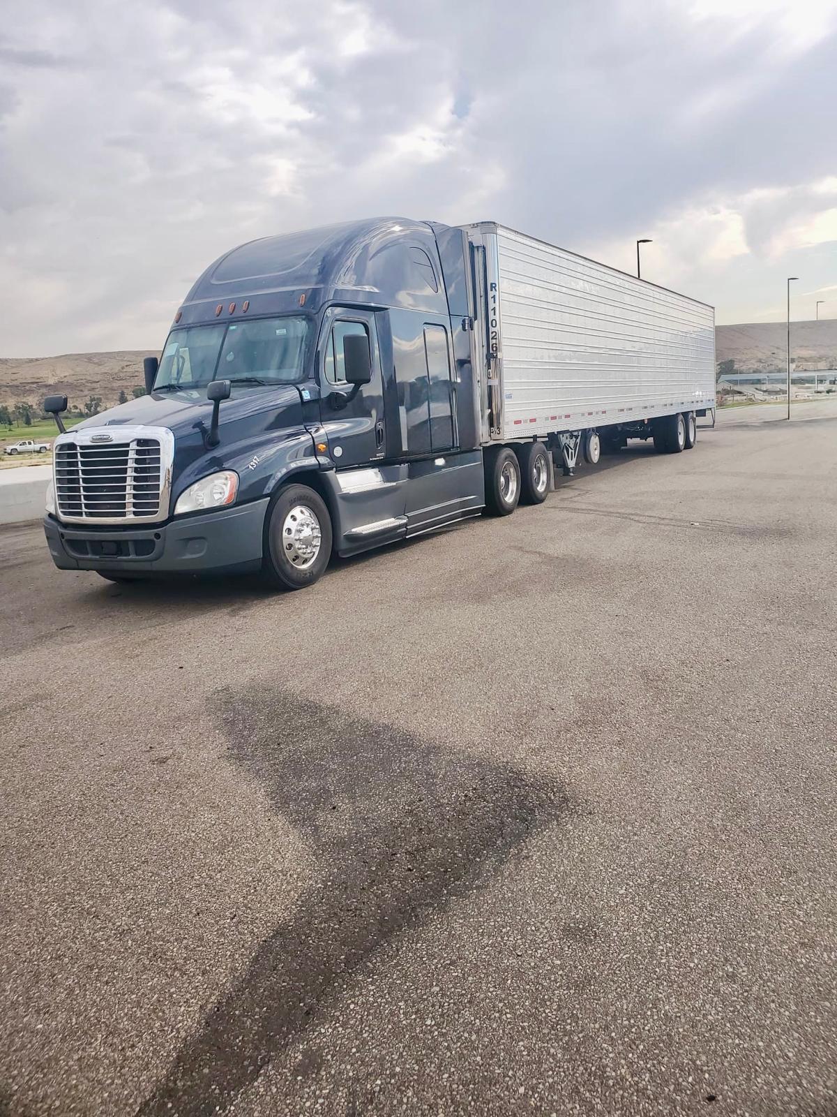 Earth Logistics Freightliner semi-truck with reefer trailer